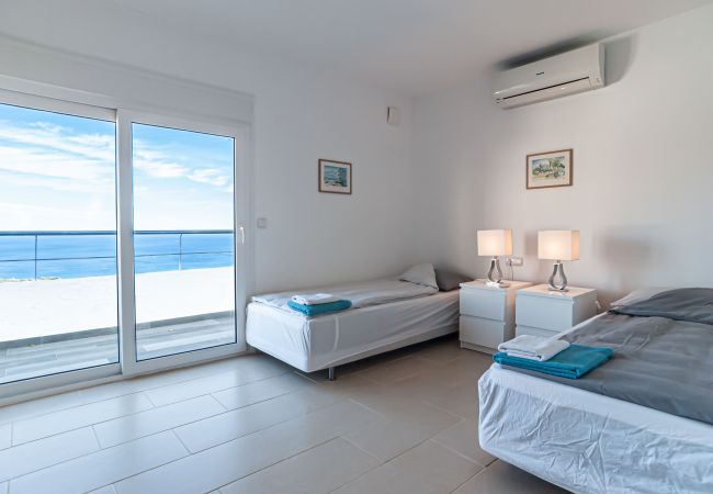 Bedroom with two single beds with sea views.