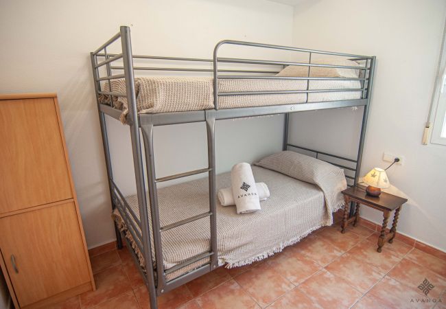 Ground floor bedroom with 2 single beds in 90cm bunk beds and an adjoining bathroom with shower.